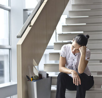Downsizing, sad business woman Sitting on Stairs